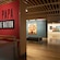 The entrance to a gallery with wooden floors and artwork displayed on the walls and the words ‘Toi Te Papa, Art of the Nation’